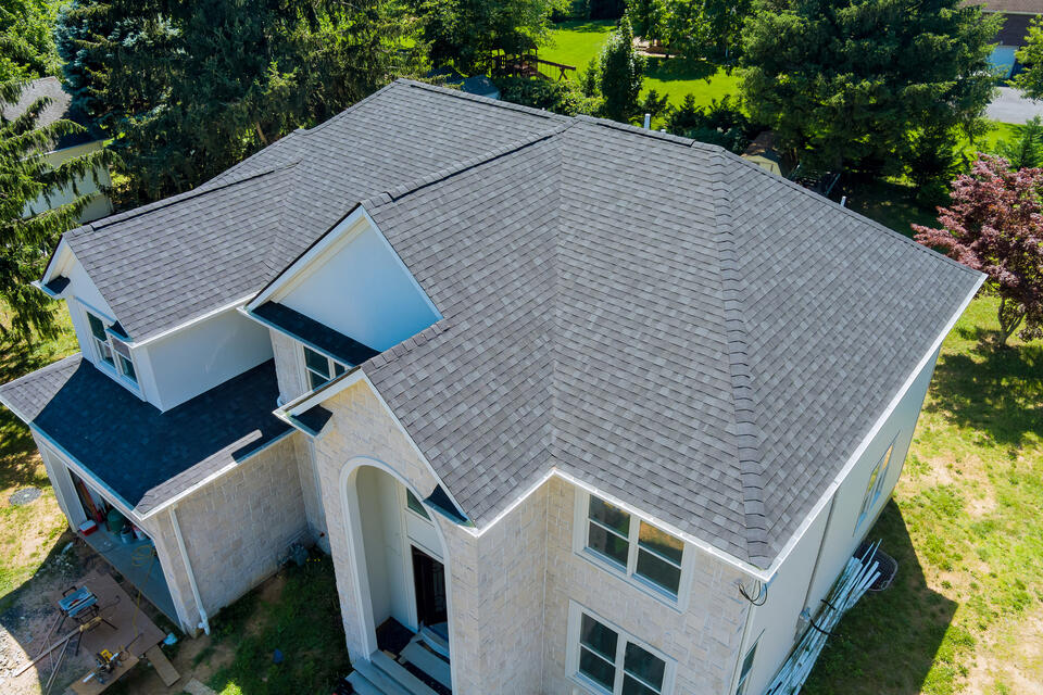 best roof shingles-aerial view of white house with gray roof shingles