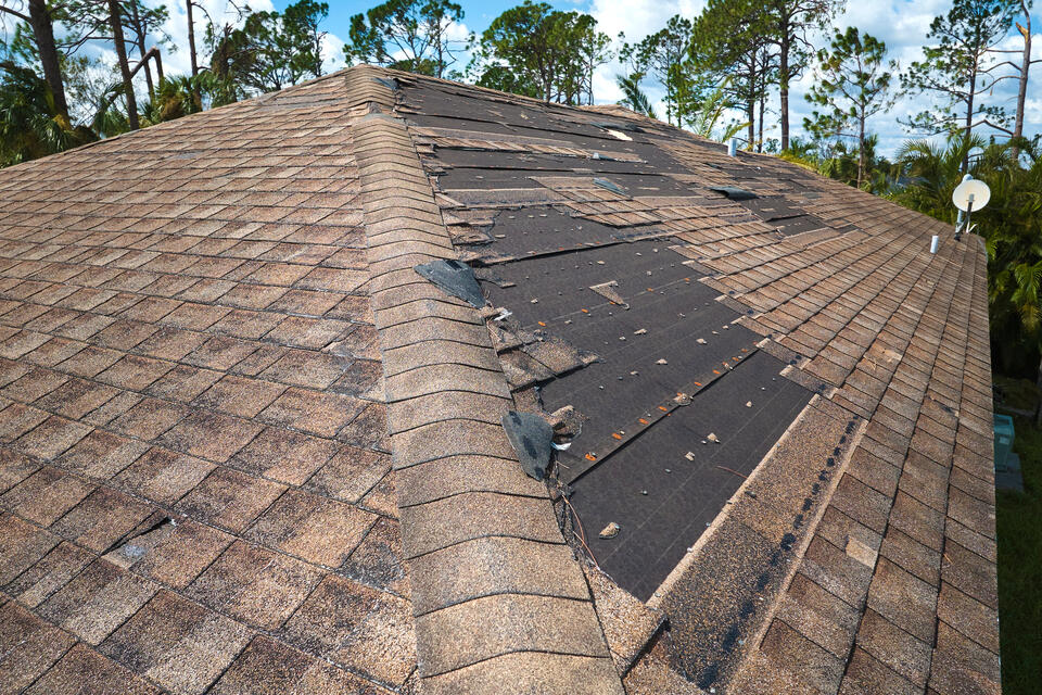 emergency roof repair-large sections of missing shingles on brown roof