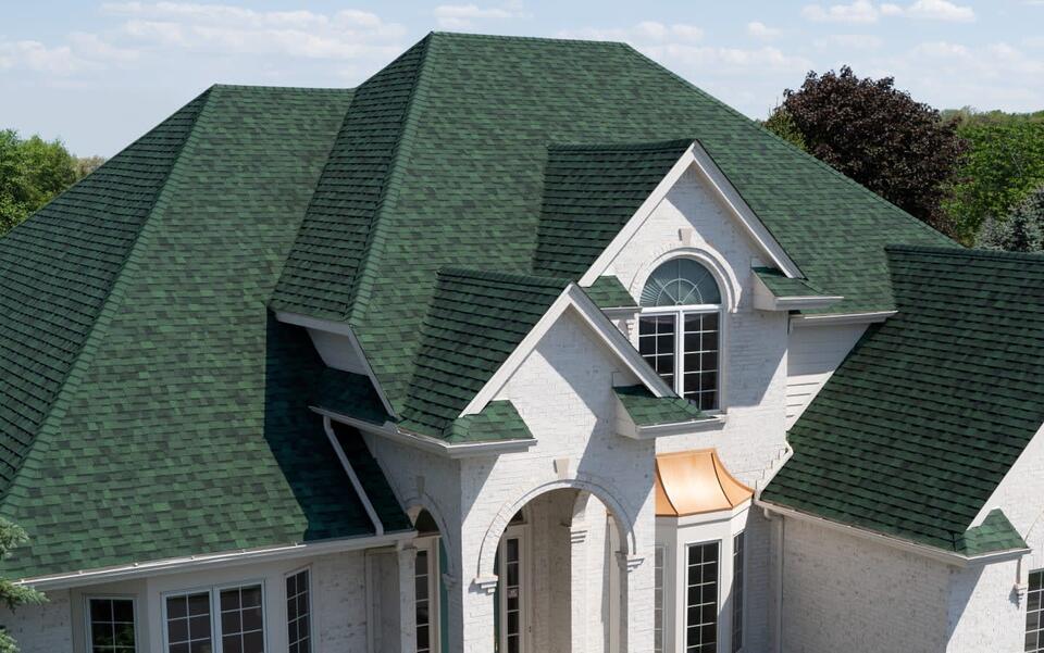 gaf vs owens corning-chateau green owens corning shingles on white sided house