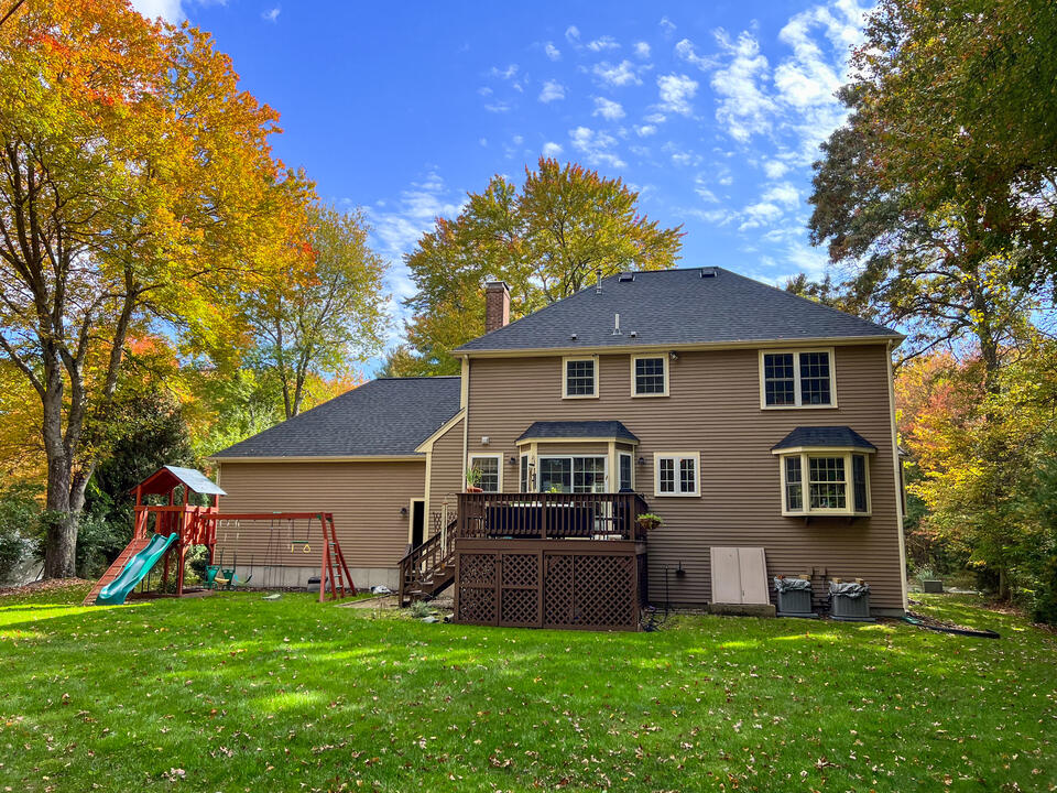 hip roof vs gable-hip roofing on brown sided house