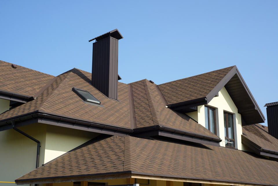 how much does a new roof cost-house with new brown shingle roofing