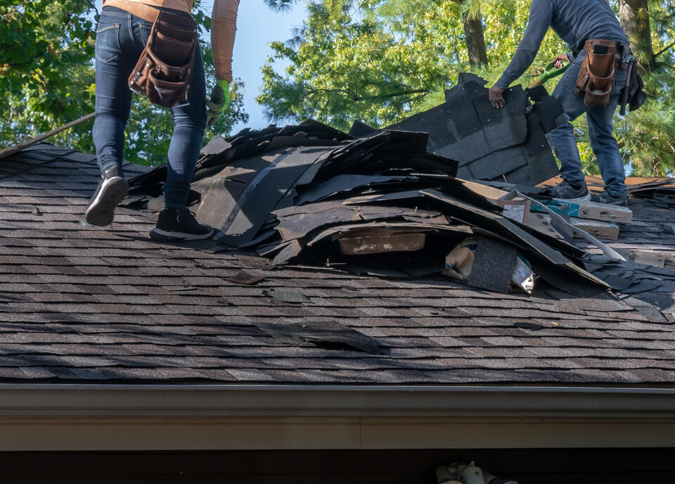 how much does a new roof cost-roofers removing old roofing materials