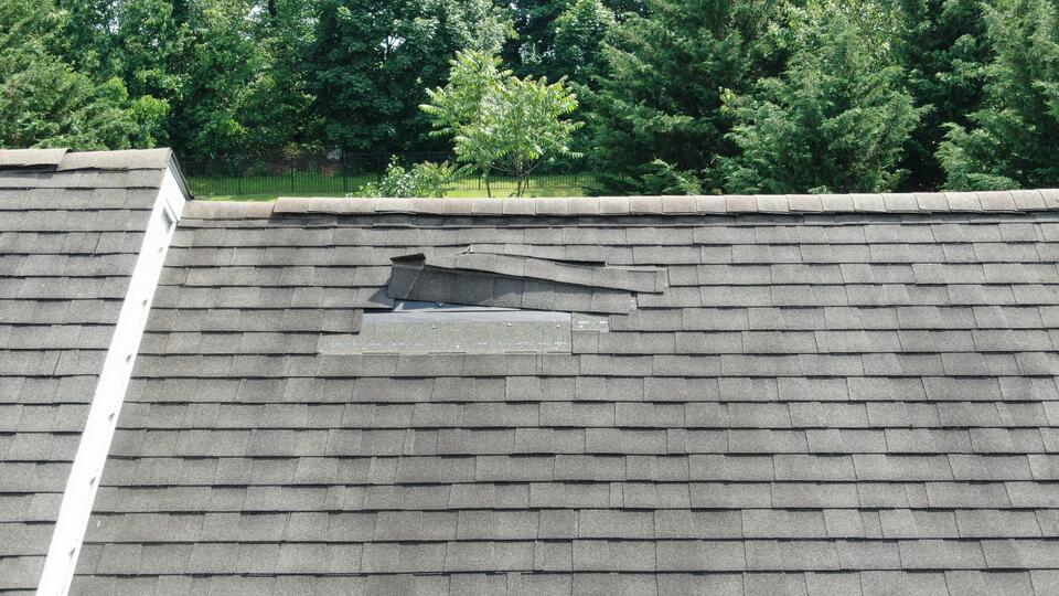 missing shingles-gray roof shingles with missing section of shingles