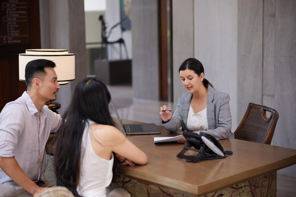 roof financing-couple going over financing terms with female banker