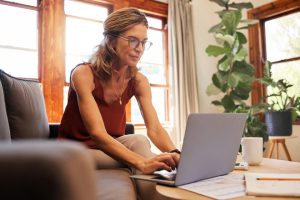 roof financing- woman on laptop going over financing options