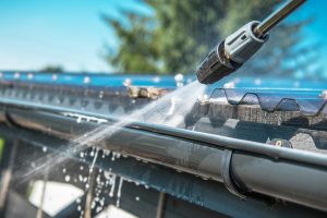 roof washing-close up of gutters being power washed