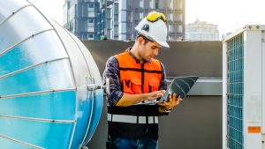 laptop man roof commercial inspection