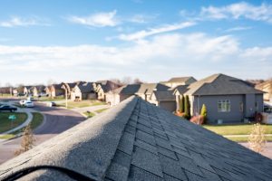 view down the top of residential roof ridge cap shingles