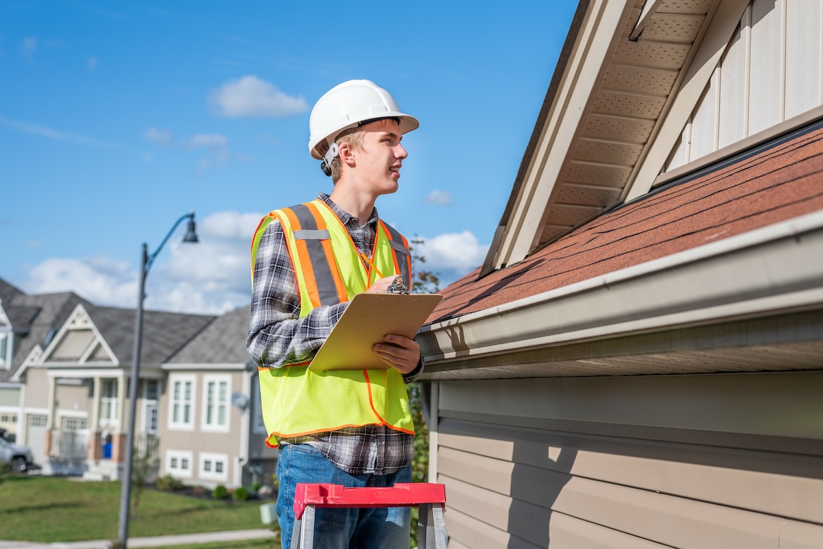 worker conducting roof inspection